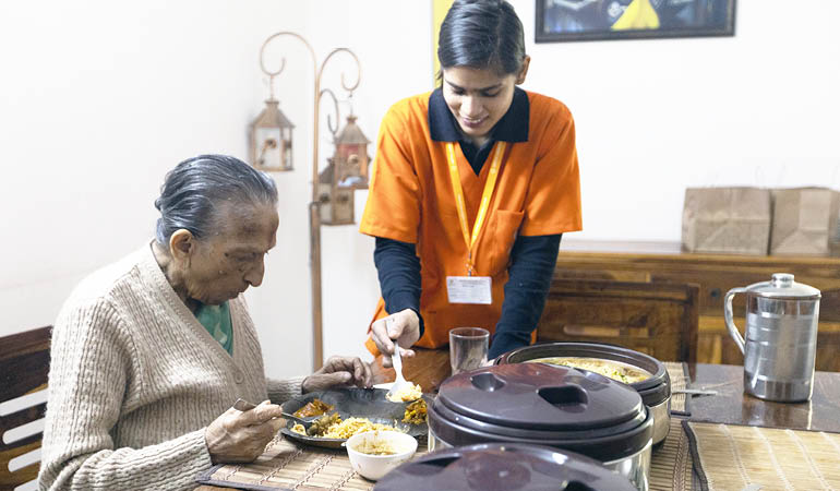 A senior resident participating in a group exercise class, showcasing active Senior living in India with geriatric healthcare.